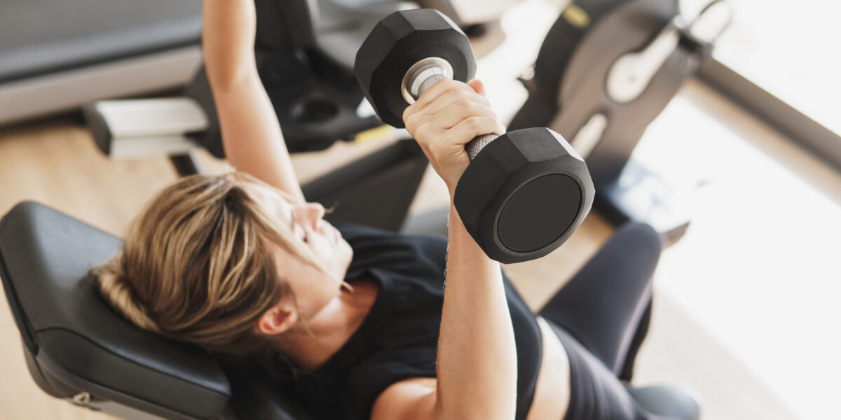 Young athletic woman doing strength training exercises